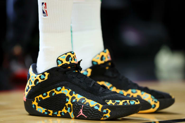 Boston Celtics forward Jayson Tatum's black and gold Jordan Brand sneakers.